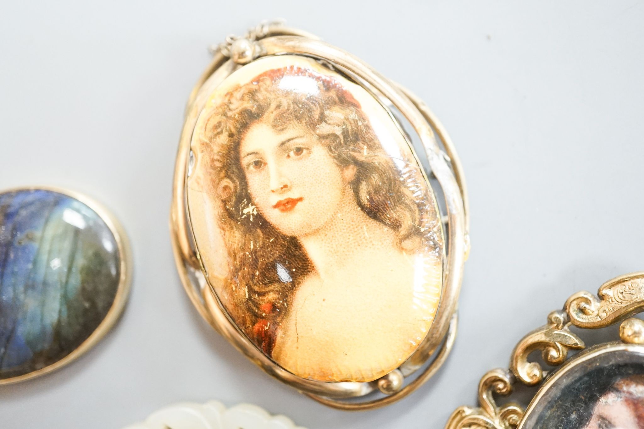 A 19th century gilt metal mounted brooch, with inset oval painted wax bust of a lady to dexter, 60mm and four other items including a 9ct mounted oval tiger's eye quartz pendant.